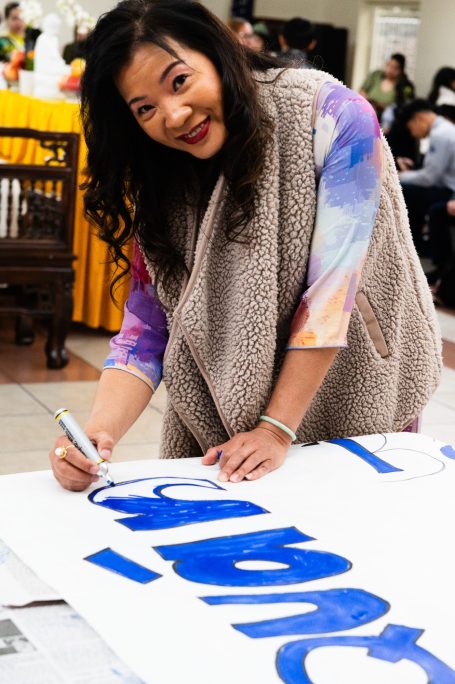 A volunteer making a poster